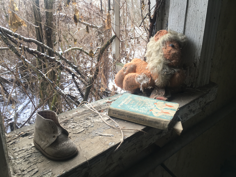 A small shoe, a book and an old stuffed animal line the window of an abandoned home in the exclusion zone. (Terrell Jermaine Starr/The Root)